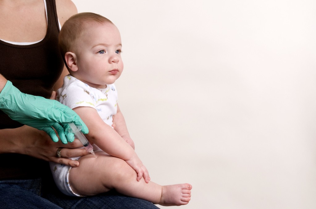 Baby receiving his scheduled vaccine